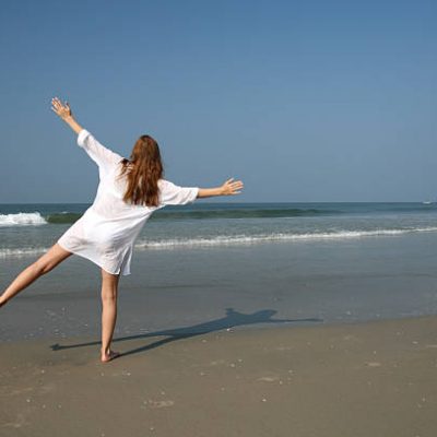 Woman on the beach near sea and blue sky